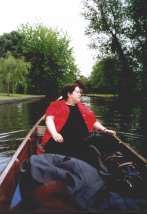 Ali lying back in a punt